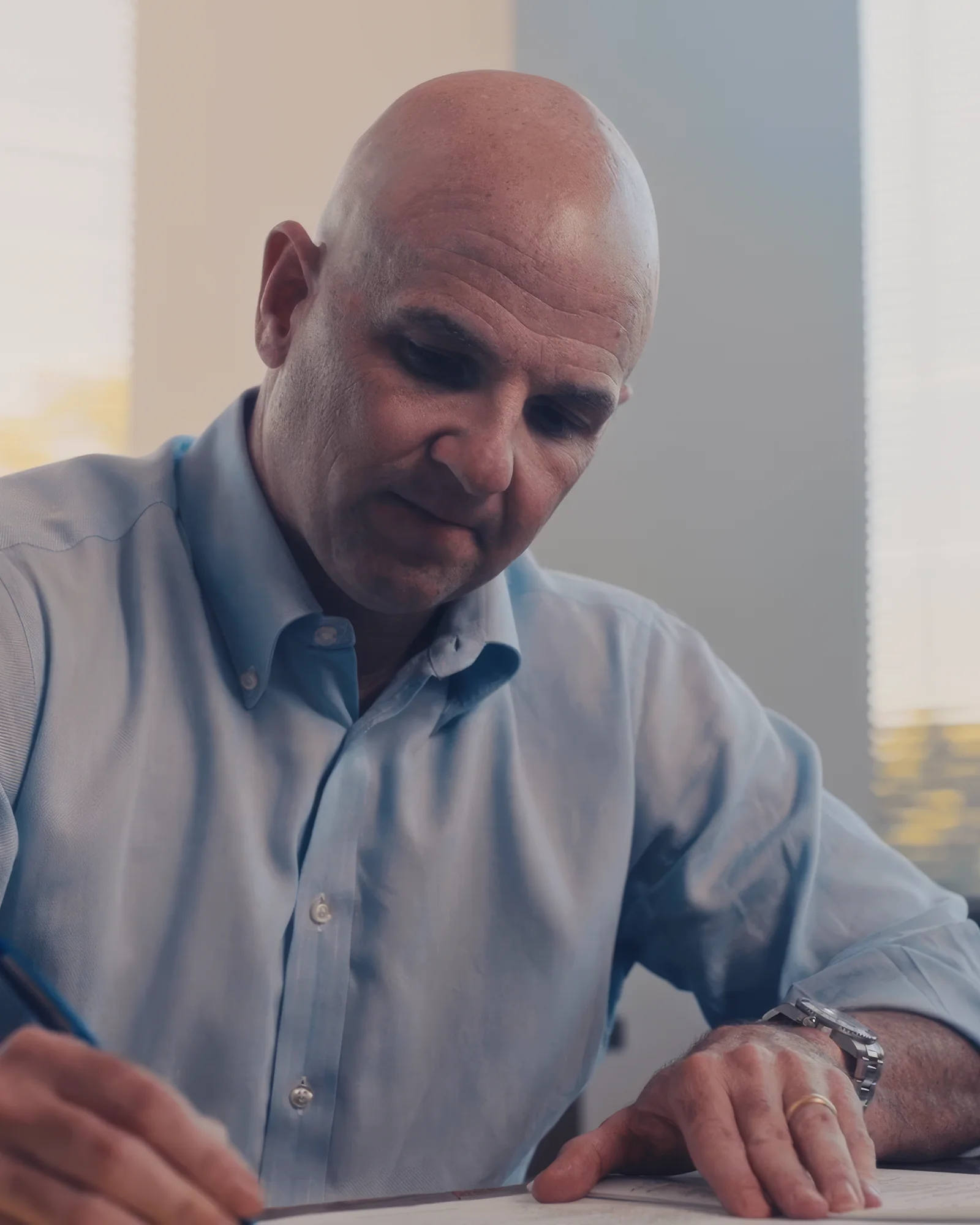 Attorney writing notes while answering legal FAQ video questions