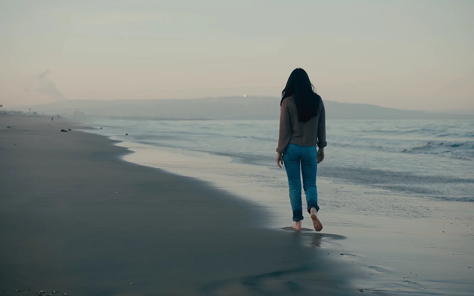 Attorney walking on the beach in vertical-friendly FAQ video b-roll