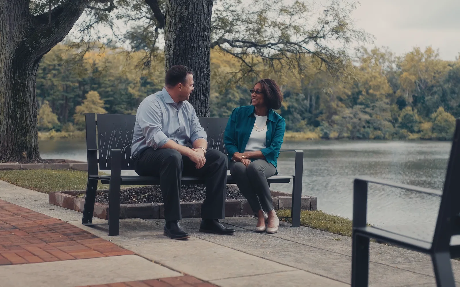 Client testimonial interview filmed on a bench by the water