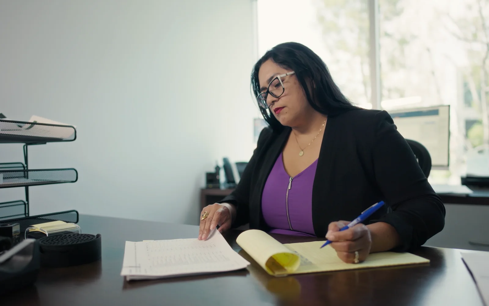 Legal team member writing research notes for a law firm FAQ video